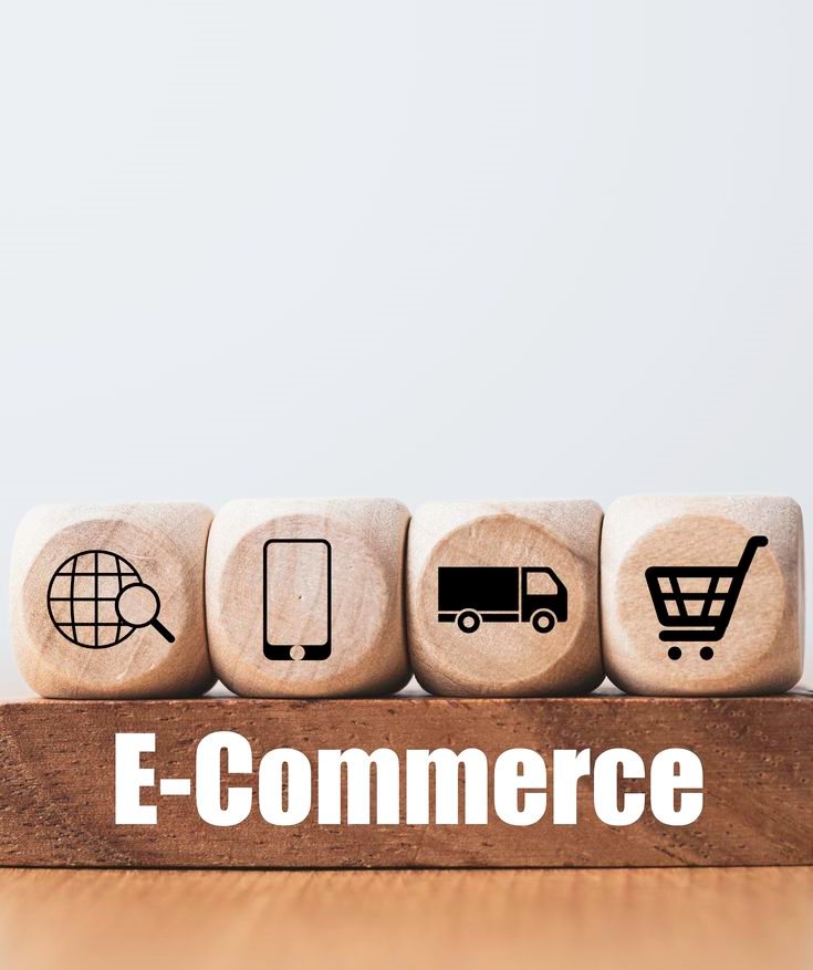 Wooden blocks with search, phone, delivery and cart icons above the word E-Commerce