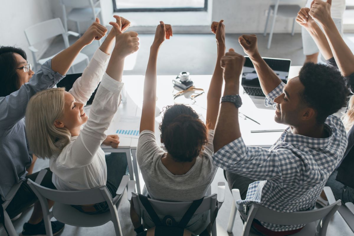A team celebrating a launch around a table
